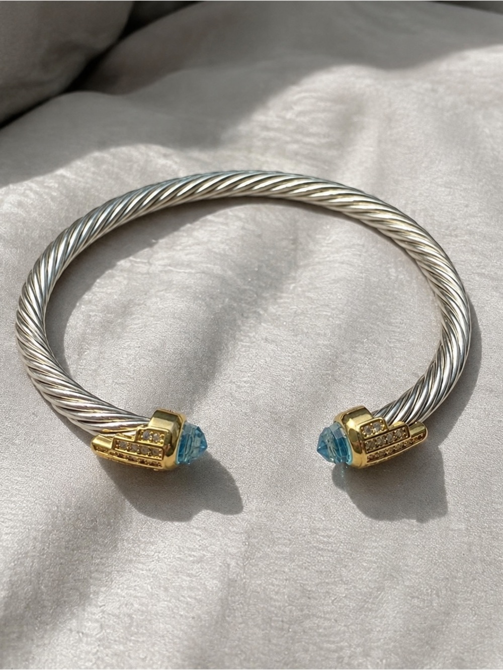 Silver-Tone Cable Cuff Bracelet with Gold Accents and Blue Crystal Ends